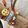 Smiley Armband aus vergoldetem Silber und Stoffkordel