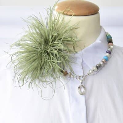 Stylische Federbrosche in Olivgrün
